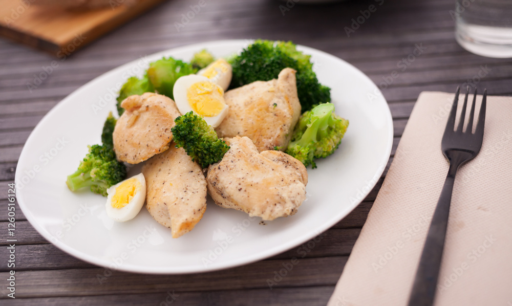 Chicken breast with broccoli and quail eggs on plate for healthy dinner Chicken breast with broccoli and quail eggs on plate for healthy dinner