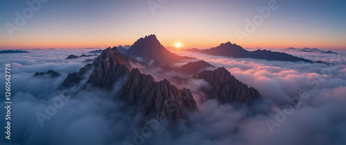 Sunrise over foggy mountain peaks