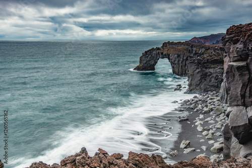 Arch in rocks on the Vestmannaeyjar  Heimaey  Westman islands in Iceland. photo