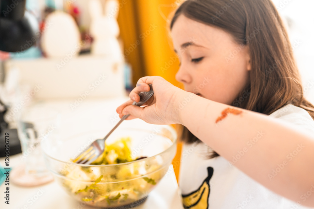 Little girl eats salad at home. Healthy food for children concept. Little girl eats salad at home. Healthy food for children concept.