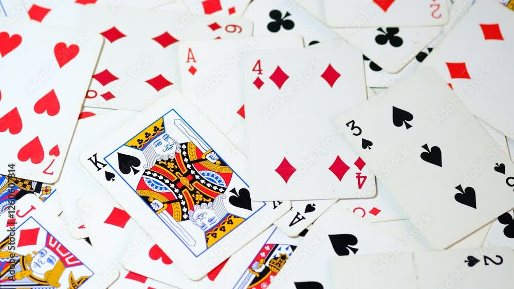 Randomly placed playing cards , scattered on a table from a playing deck. Randomly placed playing cards , scattered on a table from a playing deck.