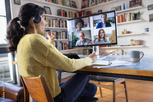 Woman working from home on a video call with coworkers