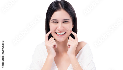 Cheerful young woman with bright smile pointing to cheeks, expressing happiness and confidence. Happy girl get Thooth Whitening  Beautiful woman has beautiful tooth, white teeth, nice tooth alignment.