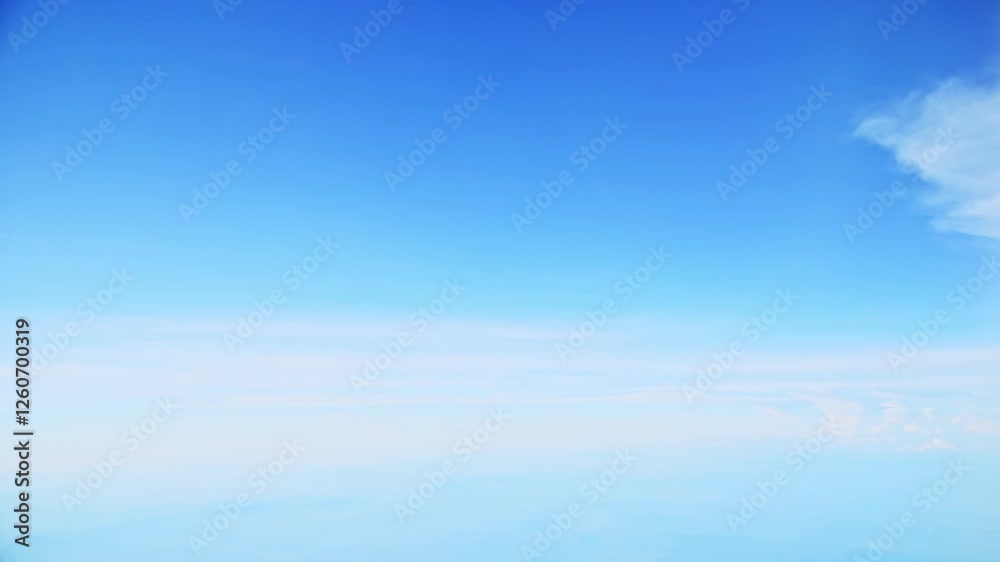 Aerial view of white clouds, from airplane window with blue sky Aerial view of white clouds, from airplane window with blue sky