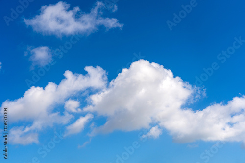 Serene Blue Sky with Fluffy White Clouds Capturing Tranquility