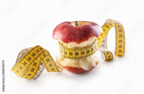 Red apple wrapped with measuring tape on a white background photo