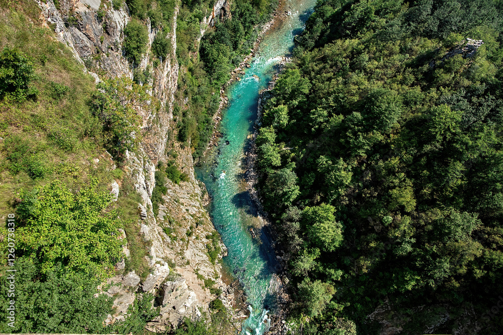 Discovering the hidden beauty of a vibrant river weaving through rugged cliffs