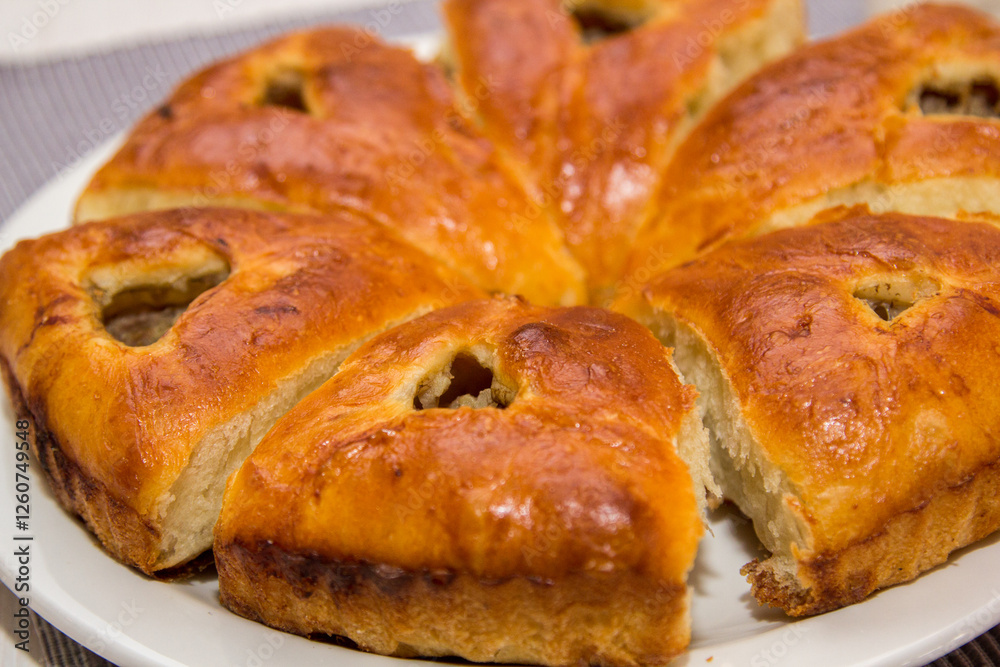 Freshly baked buns with raisins on a white plate Freshly baked buns with raisins on a white plate