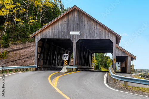 A view towards the covered bridge on main street at Vaughan Creek, New Brunswick in the fall photo