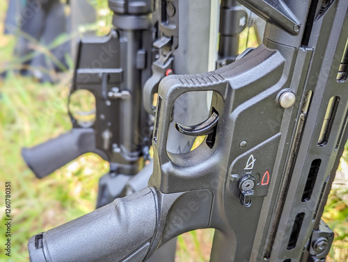 A variety of small arms on a wooden rack. Rifles, carbines and shotguns at the shooting range photo