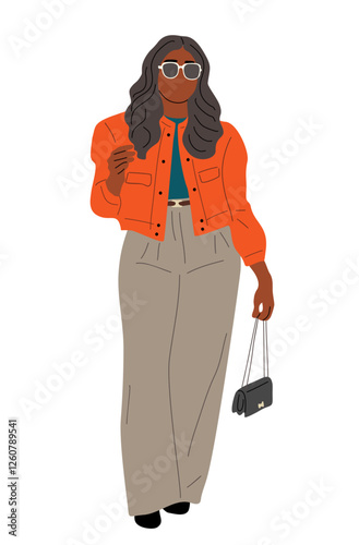 A woman in a bright orange jacket and tan pants is walking down the street. She is holding a black purse and wearing sunglasses. The image has a bright and cheerful mood, with the womans outfit