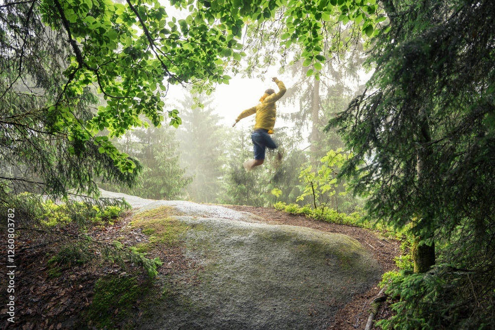 Obraz premium Joyful jump in a lush green forest.