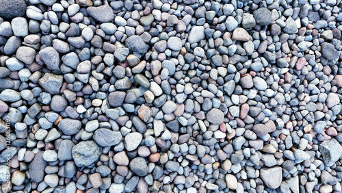 Canvas Print Smooth round grey pebble stones texture background.