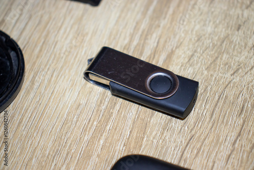 Wallpaper Mural Close-up of a modern USB flash drive on a wooden surface, showcasing its sleek design and practicality for data storage and transfer. Torontodigital.ca