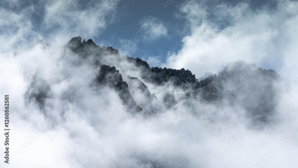 Fototapeta premium Cloud-covered mountain summit