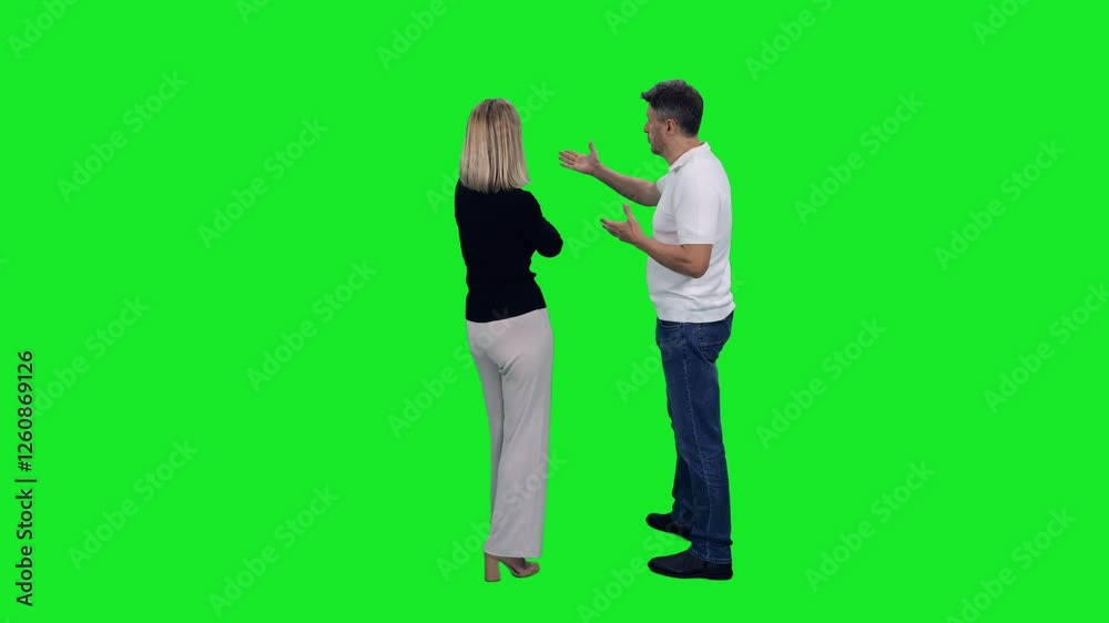 Back view of adult man something explaining to stylish woman standing on green chroma key background, 4k pre-keyed footage Back view of adult man something explaining to stylish woman standing on green chroma key background, 4k pre-keyed footage
