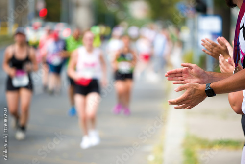 Fans cheering up a marathon runners