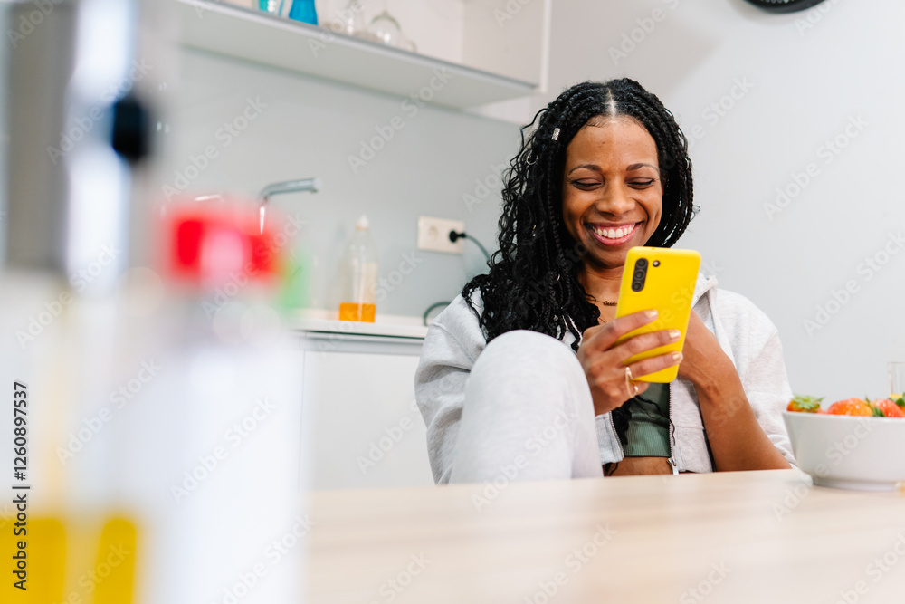 Happy woman using smartphone and having breakfast at home Happy woman using smartphone and having breakfast at home