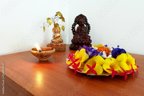 Candles and flowers with Lord buddha 