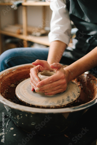 Process of making a unique ceramic shape. Potter creates a ceramic bowl in the pottery studio.