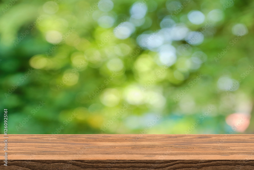 Abstract blurred green bokeh and brown wooden tabletop texture perspective counter for promoting and advertising product on display Abstract blurred green bokeh and brown wooden tabletop texture perspective counter for promoting and advertising product on display