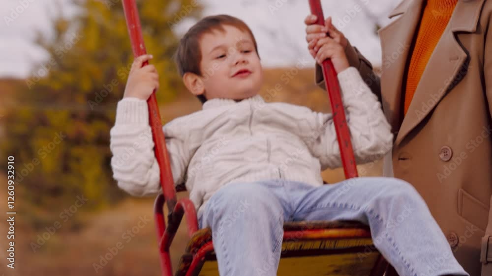 Mother swings son on swing in park. Mother swings son on swing amid scenery sharing moment in park. Mother swings son on swing in park enjoys moments creating experience in midst of beauty of season Mother swings son on swing in park. Mother swings son on swing amid scenery sharing moment in park. Mother swings son on swing in park enjoys moments creating experience in midst of beauty of season