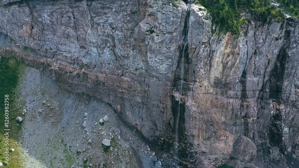 custom made wallpaper toronto digitalAn aerial footage of Bargfall Waterfall pouring into the Alpine Oeschinen Lake on a sunny day in Kandersteg, Switzerland.