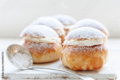 Homemade Semla or semlor, vastlakukkel, laskiaispulla - traditional Scandinavian sweet bun especially Fastelavn Shrove Monday and Shrove Tuesday. photo