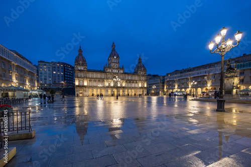 Night view of Plaza María Pita in A Coruña, Galicia, with its illuminated architecture reflected on the wet ground after the rain.
 photo