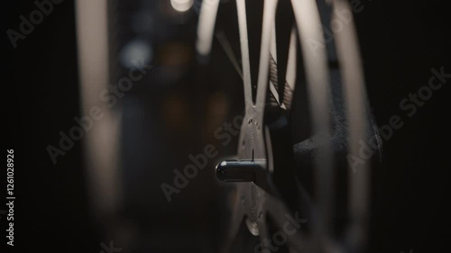 Close ups of a vintage 8MM projector spools moving and playing film 