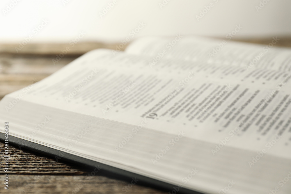 Open Holy Bible in English language on wooden table, closeup Open Holy Bible in English language on wooden table, closeup