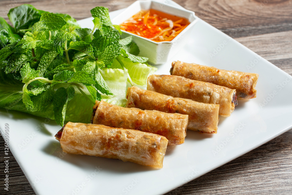 A view of a plate of egg rolls. A view of a plate of egg rolls.