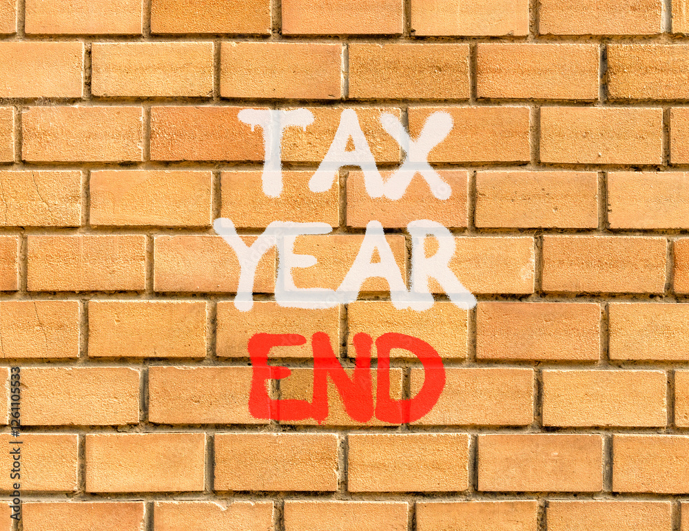 Tax year end symbol. Concept words Tax year end on beautiful brown brick wall. Beautiful brown brick wall background. Business tax year end concept. Copy space.