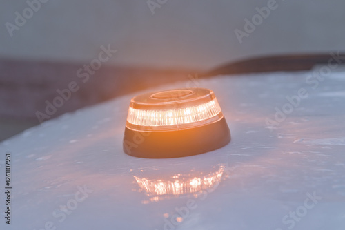 
v-16 emergency light on top of a vehicle on a rainy day