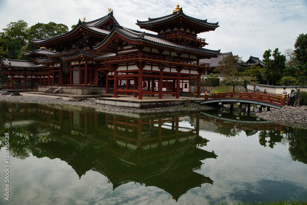 Fototapeta premium View with its reflection in the water of the Byōdō-in, and its garden, is a Buddhist temple located in the city of Uji, Kyoto, Japan. The image appears on the 10 yen coin. World Heritage Site.