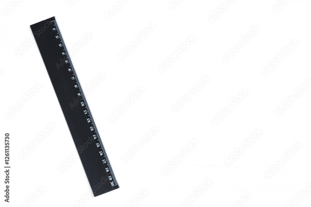One black ruler on white table, top view. Space for text One black ruler on white table, top view. Space for text