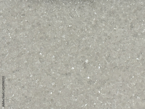 A background of sugar crystals, creating a shiny texture and playful light reflections.