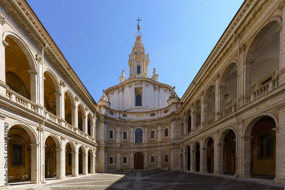 Naklejka premium The 17th century Baroque church and courtyard Chiesa di Sant Ivo alla Sapienza (University of Rome) by Francesco Borromini against a deep blue sky in Rome, Italy