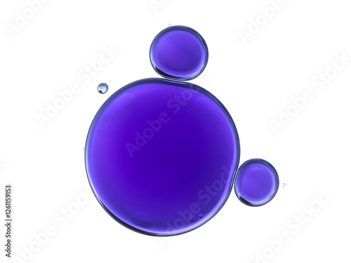 Purple colored oil bubbles and drops on white background, chemistry science experiment