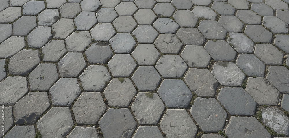 A seamless 3D-rendered stone pavement texture featuring a geometric hexagonal tile arrangement. Each stone showcases subtle color variations, cracks, and weathered surfaces, making it ideal for modern A seamless 3D-rendered stone pavement texture featuring a geometric hexagonal tile arrangement. Each stone showcases subtle color variations, cracks, and weathered surfaces, making it ideal for modern