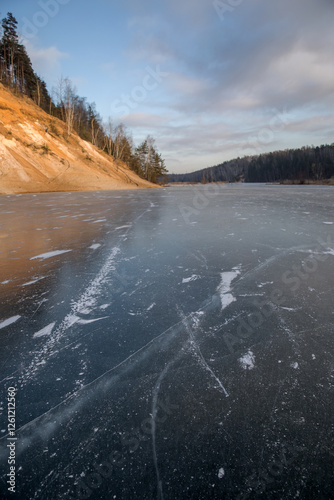 Frozen surface of a reservoir in winter. Ice. photo