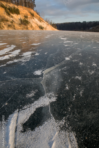 Frozen surface of a reservoir in winter. Ice. photo