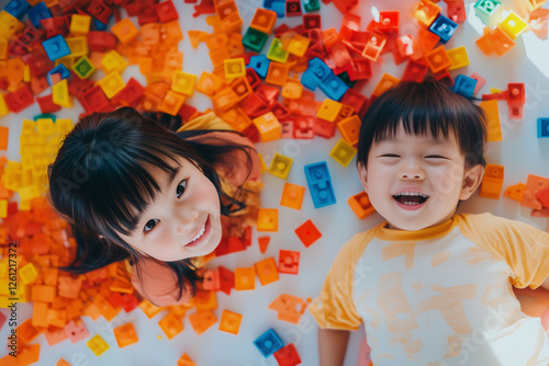 Two Asian children playing with colorful blocks. Concept of children's games, learning through play, activities for kids, early education, and child development. photo