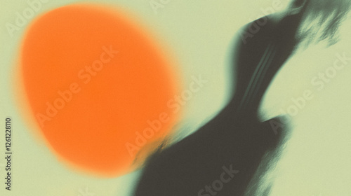 Abstract blur of orange and black shapes on soft green background