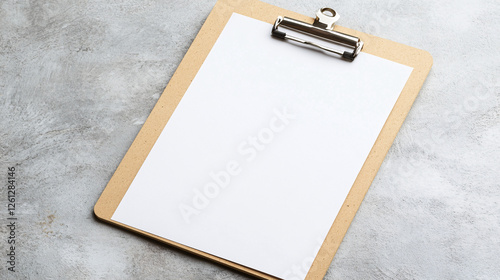 Wooden clipboard with a blank white sheet of paper lying on a textured gray surface ready for writing or office use  
