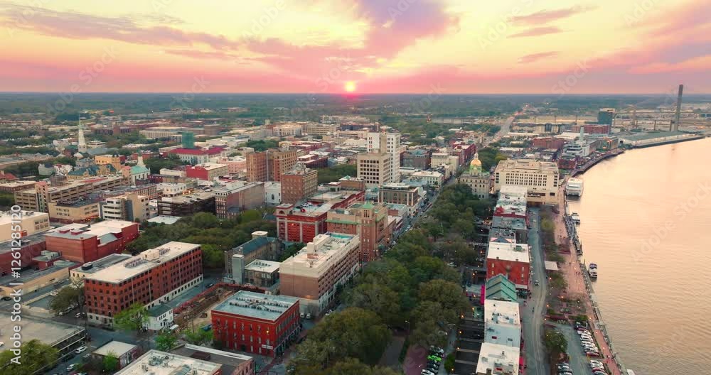 Old historic city architecture in Southern USA. View from above of illuminated streets of Savannah, Georgia at sunset.