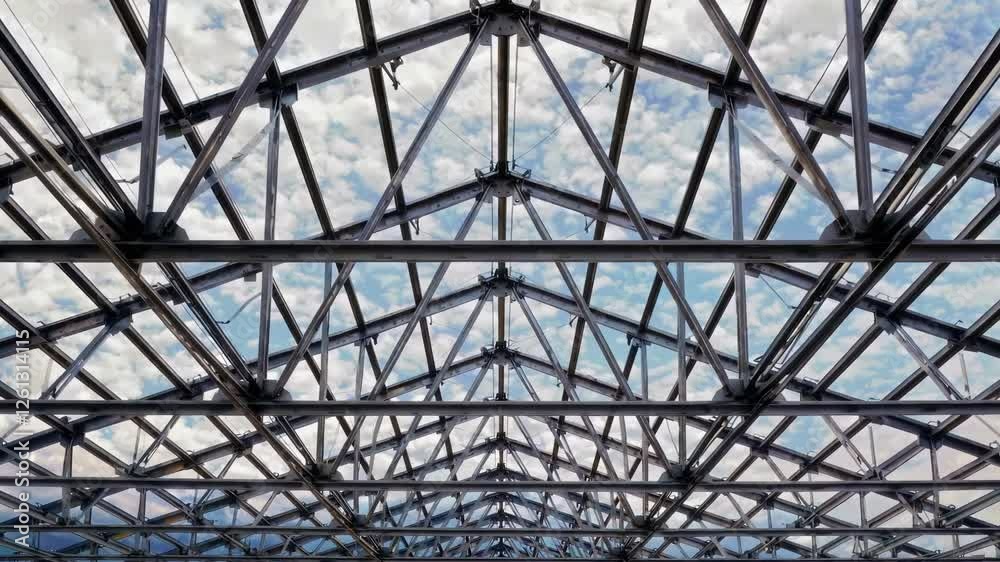 An intricate and exquisite design of a glass roof beautifully showcasing a steel framework against a cloudy sky An intricate and exquisite design of a glass roof beautifully showcasing a steel framework against a cloudy sky