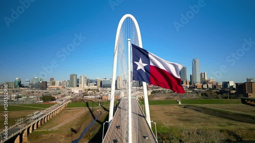 Texas state flag and Modern Margaret Hunt Hill Bridge over Trinity river in Dallas, Texas