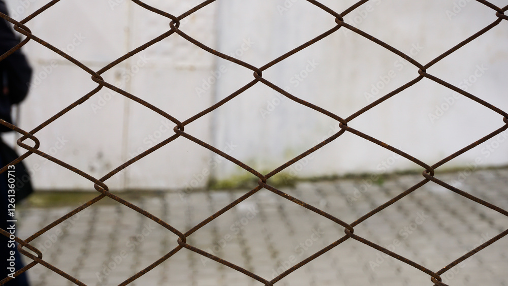 Rusty chain link fence, suggesting restricted access and security concerns Rusty chain link fence, suggesting restricted access and security concerns
