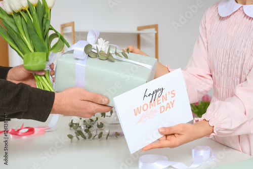 Woman giving gift box, gree...